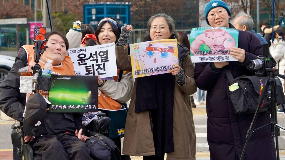 1월 18일 서울 종로 보신각, 공공운수노조 의료연대본부 주최 "내란성 급체 내리는 집회" 참가자 모습. 의료연대본부에서 나눔한 개성있는 피켓을 들고 있다.